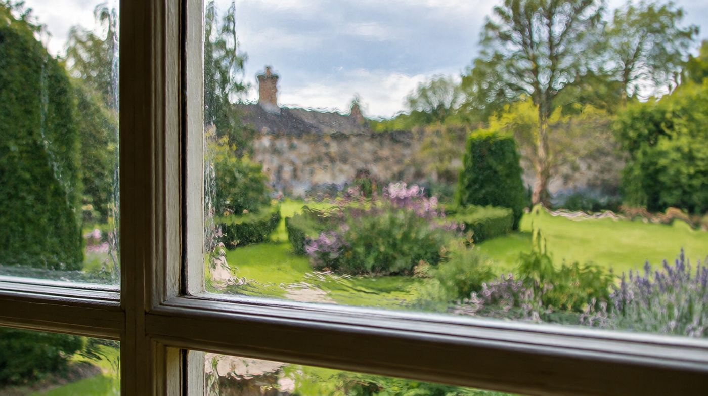 The view through an old crown glass pane in a Georgian window, visibly rippled and distorted