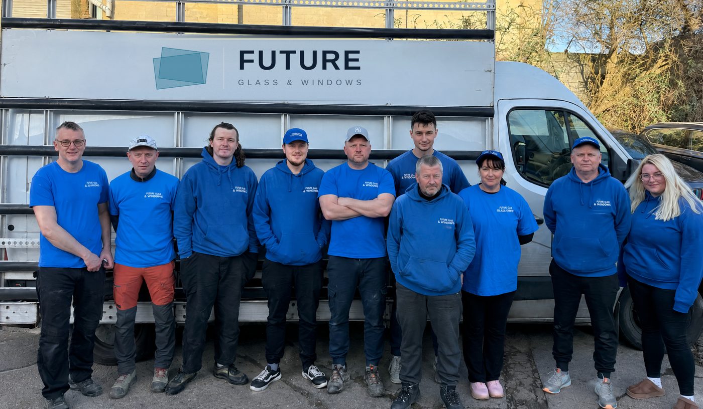 The glazing team outside the Wembley workshop, standing in front of one of the branded glass delivery vans